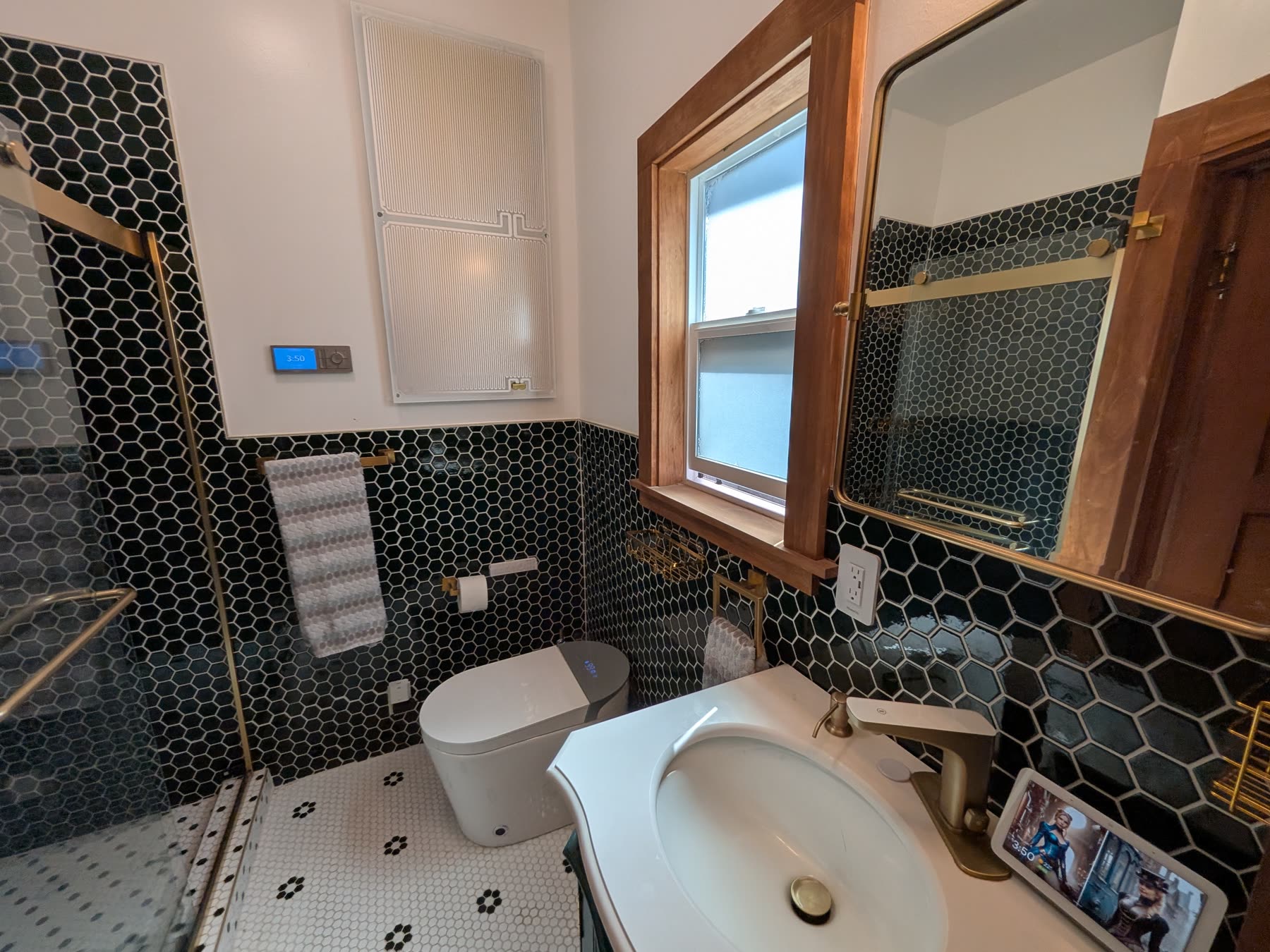 Bathroom with black hexagonal tile and glass shower