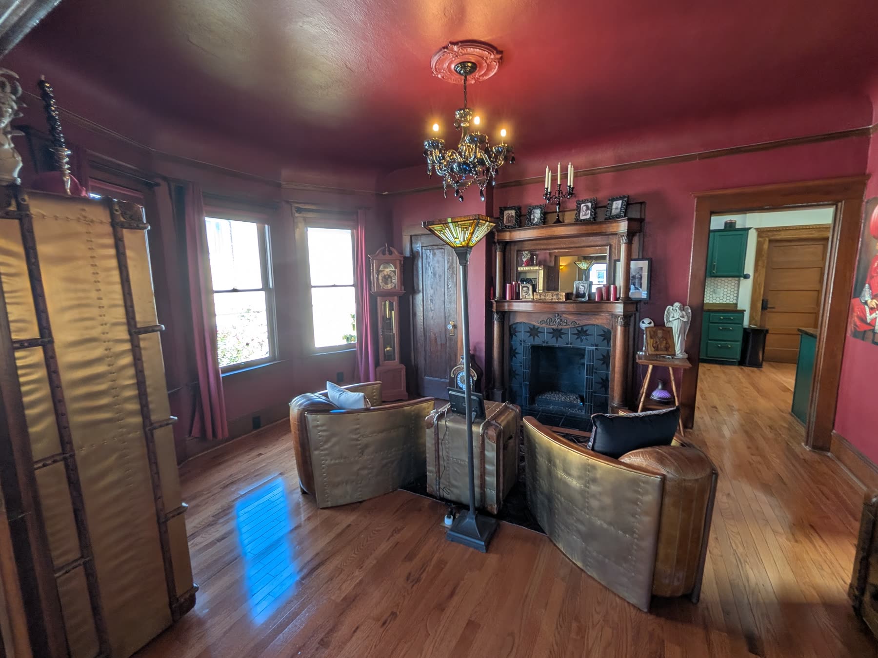 Burgundy parlor with fireplace and bay windows