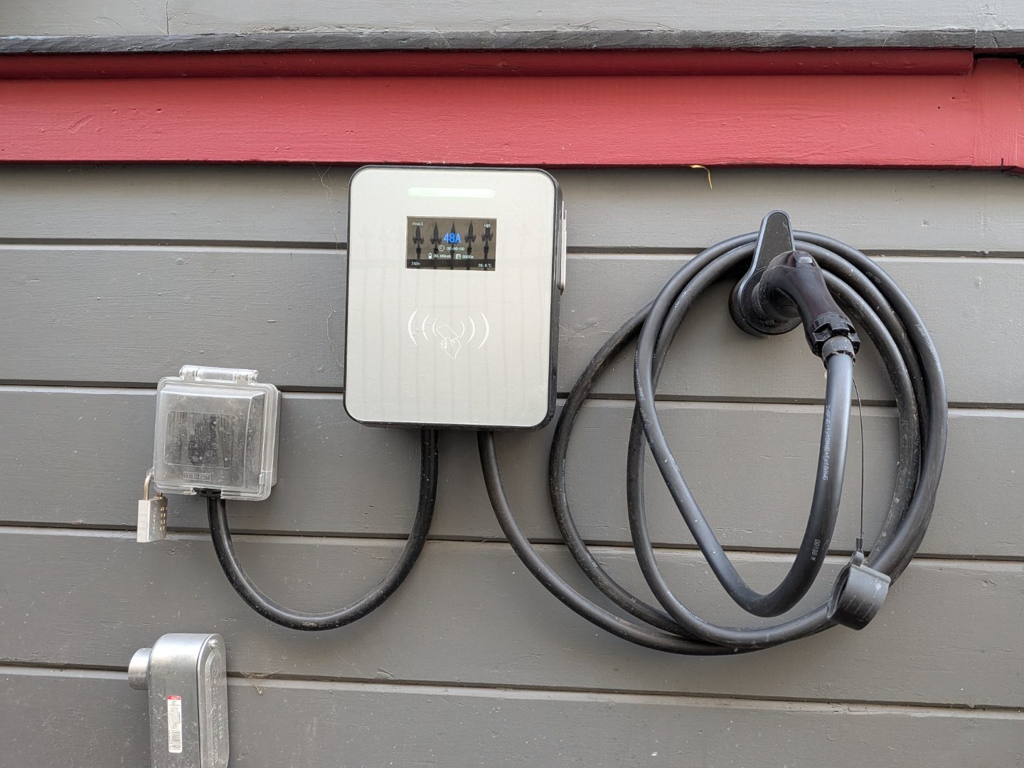 Permitted EV charger mounted on the home's exterior siding