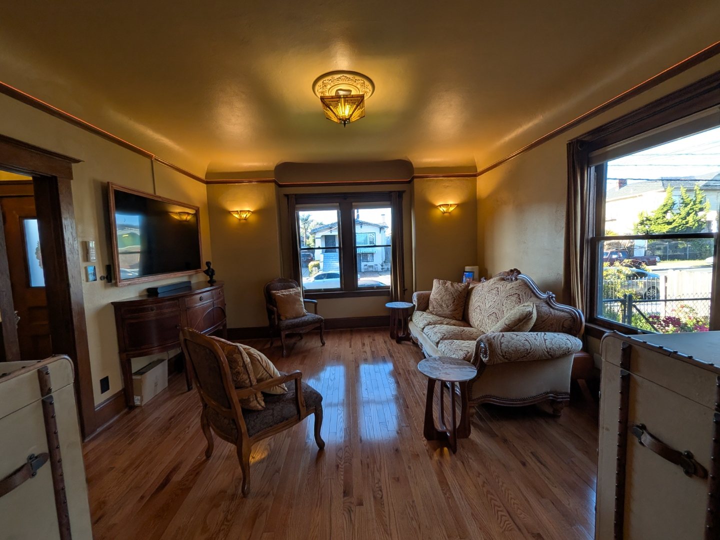 Living room with wall-mounted TV and warm evening lighting