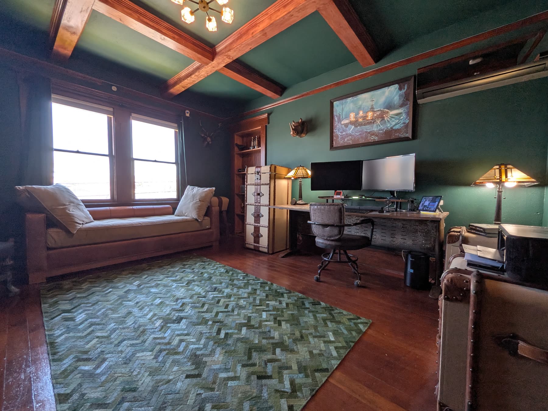 Home office with green walls, beamed ceiling and built-in daybed